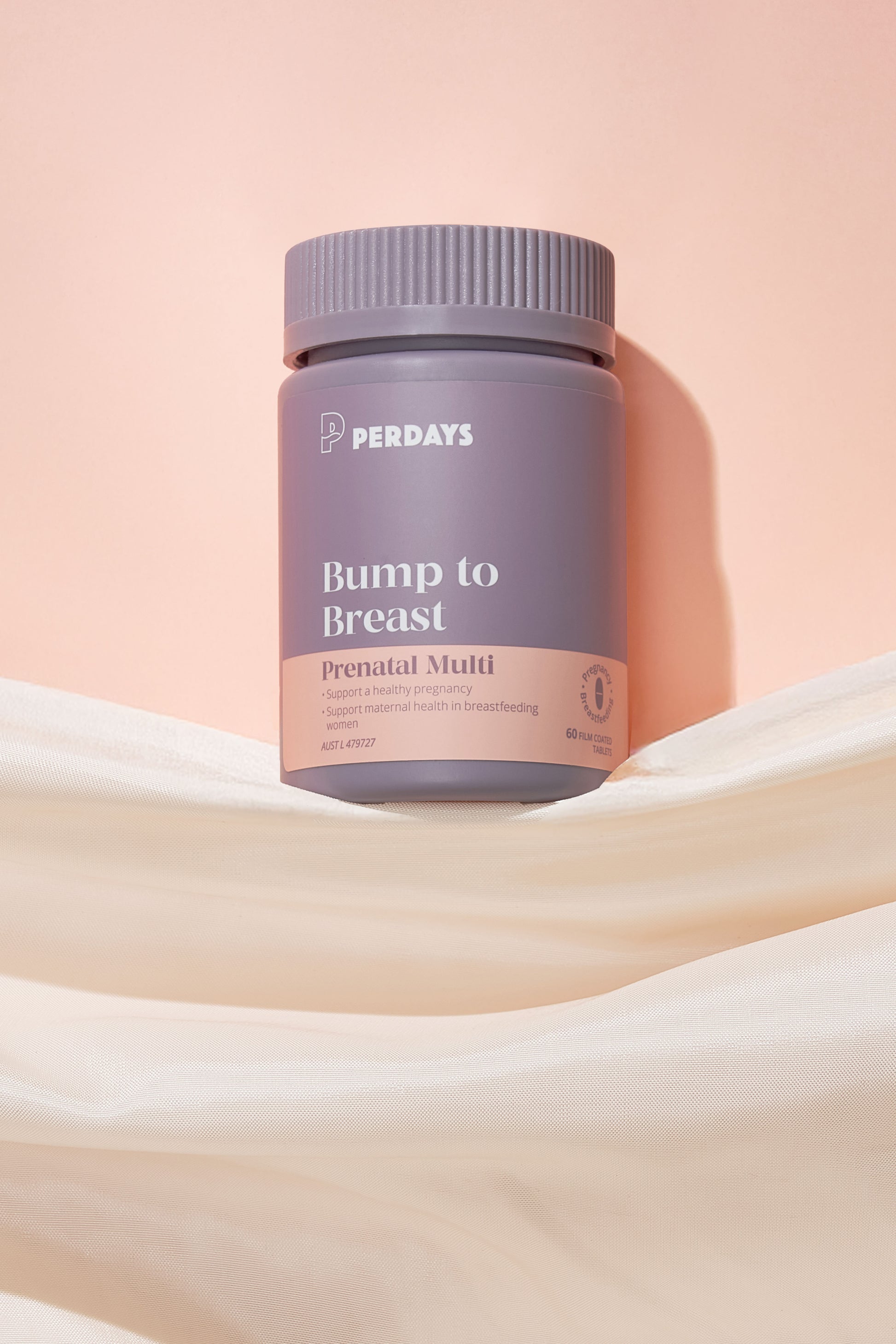 Perdays Bump to Breast prenatal multivitamin bottle on a soft pink background