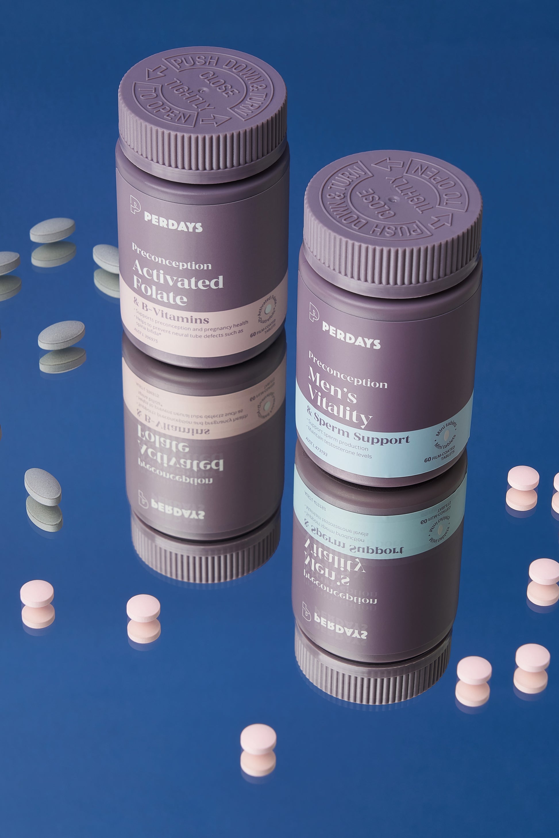 Two purple preconception supplement bottles with white labels on a reflective blue surface.