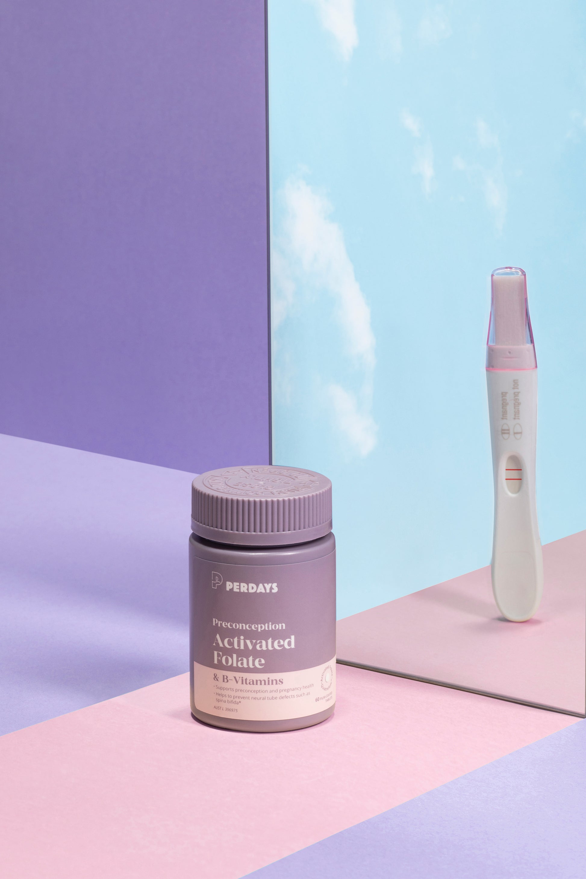 Supplement bottle labeled 'Preconception Activated Folate' with a pregnancy test on a colorful background