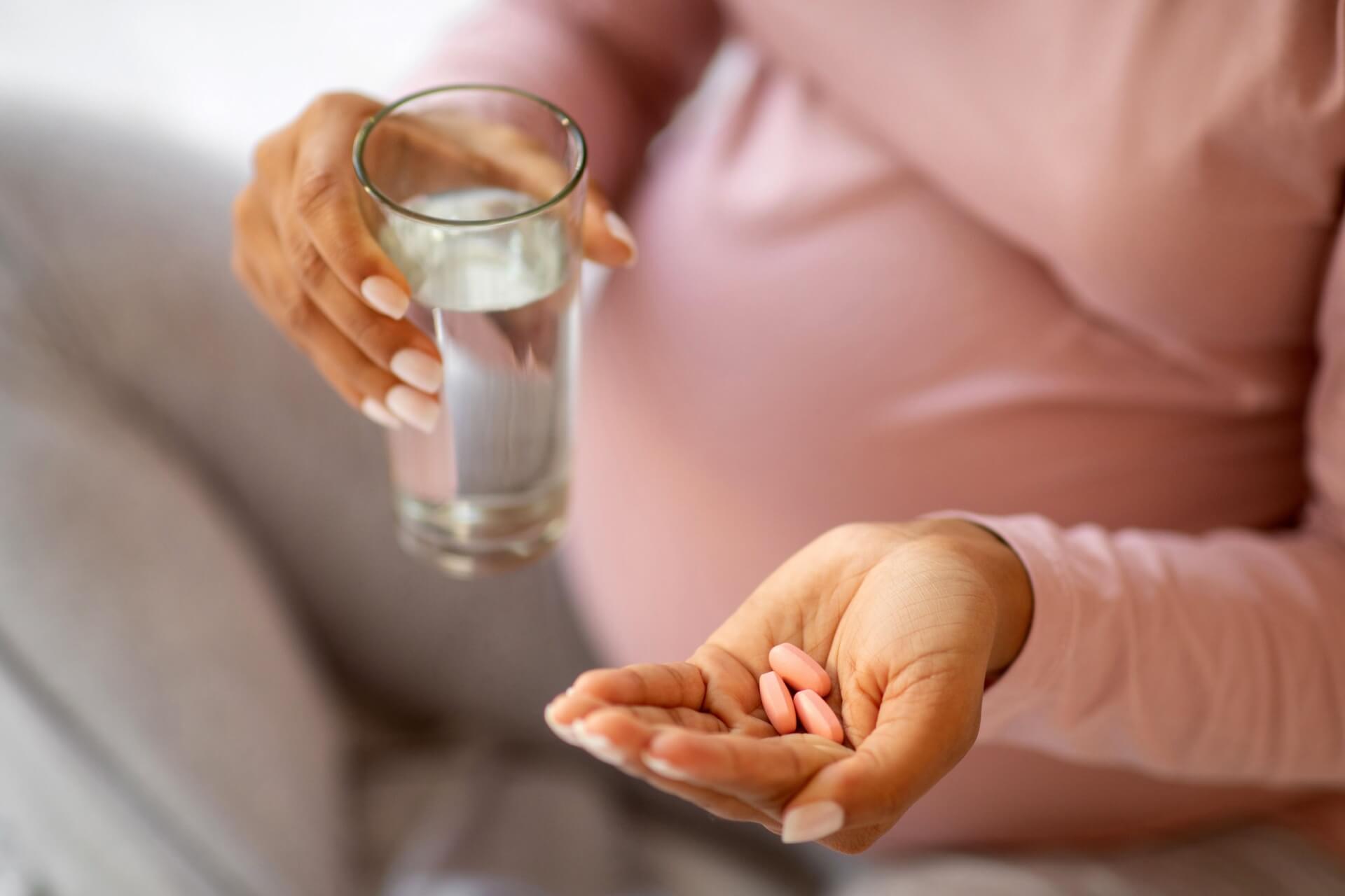 pregnant woman taking prenatal vitamins